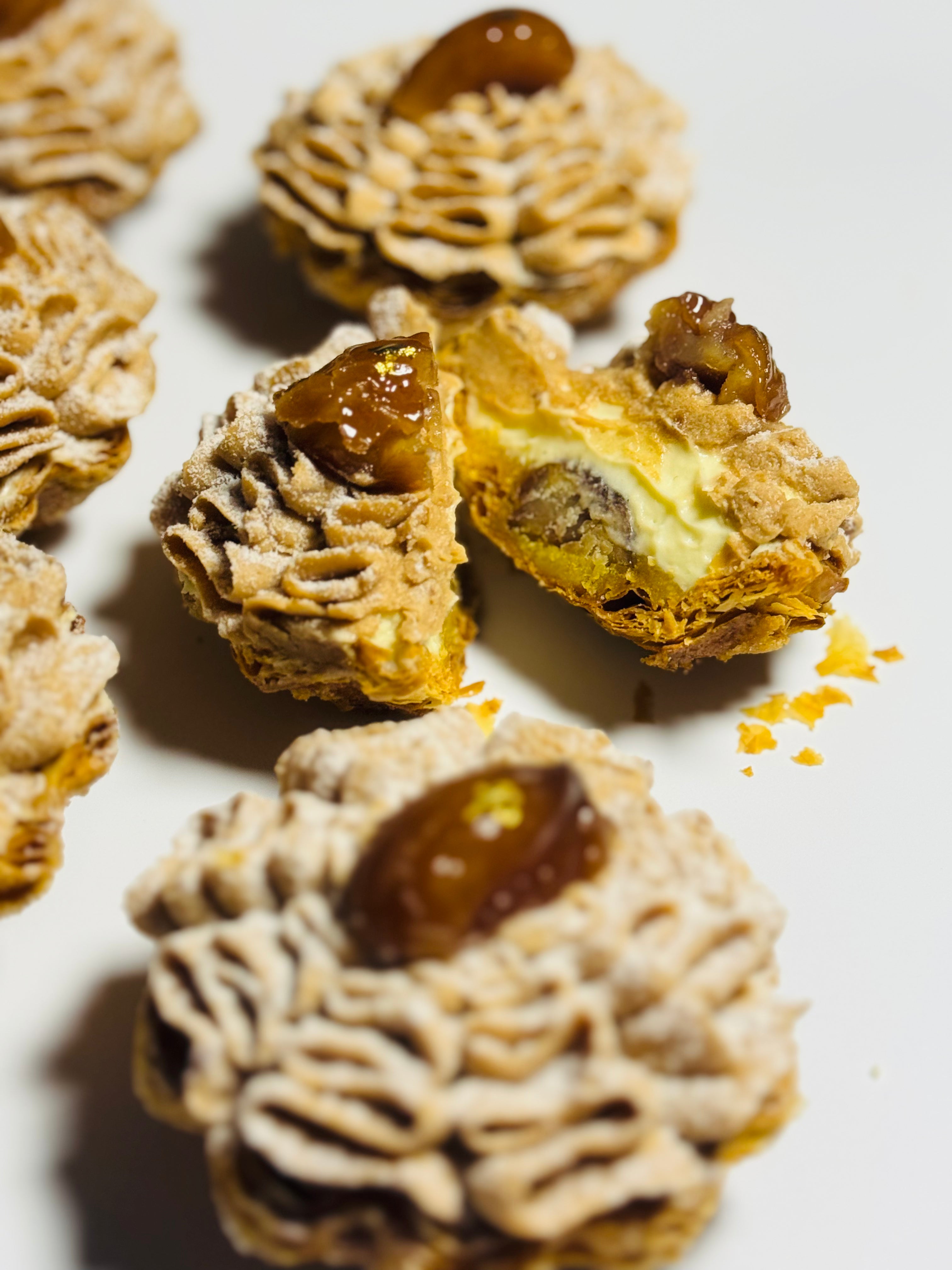 Cross-section of Mont Blanc chestnut tart revealing flaky butter pastry shell, vanilla ganache and chestnut almond cream filling — L'Œuf Atelier